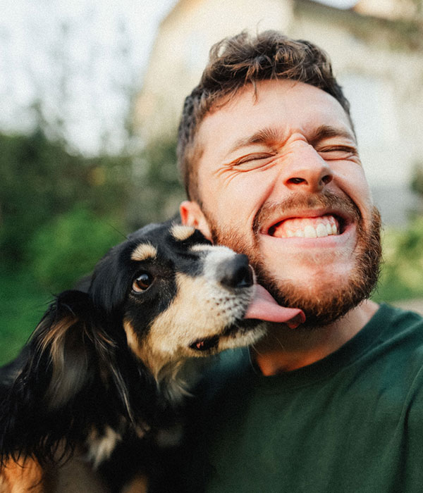 dog licking owners face